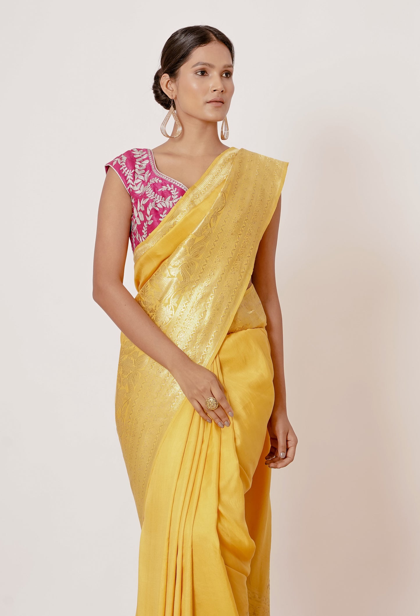 Bright yellow banrasi silk saree with pink blouse