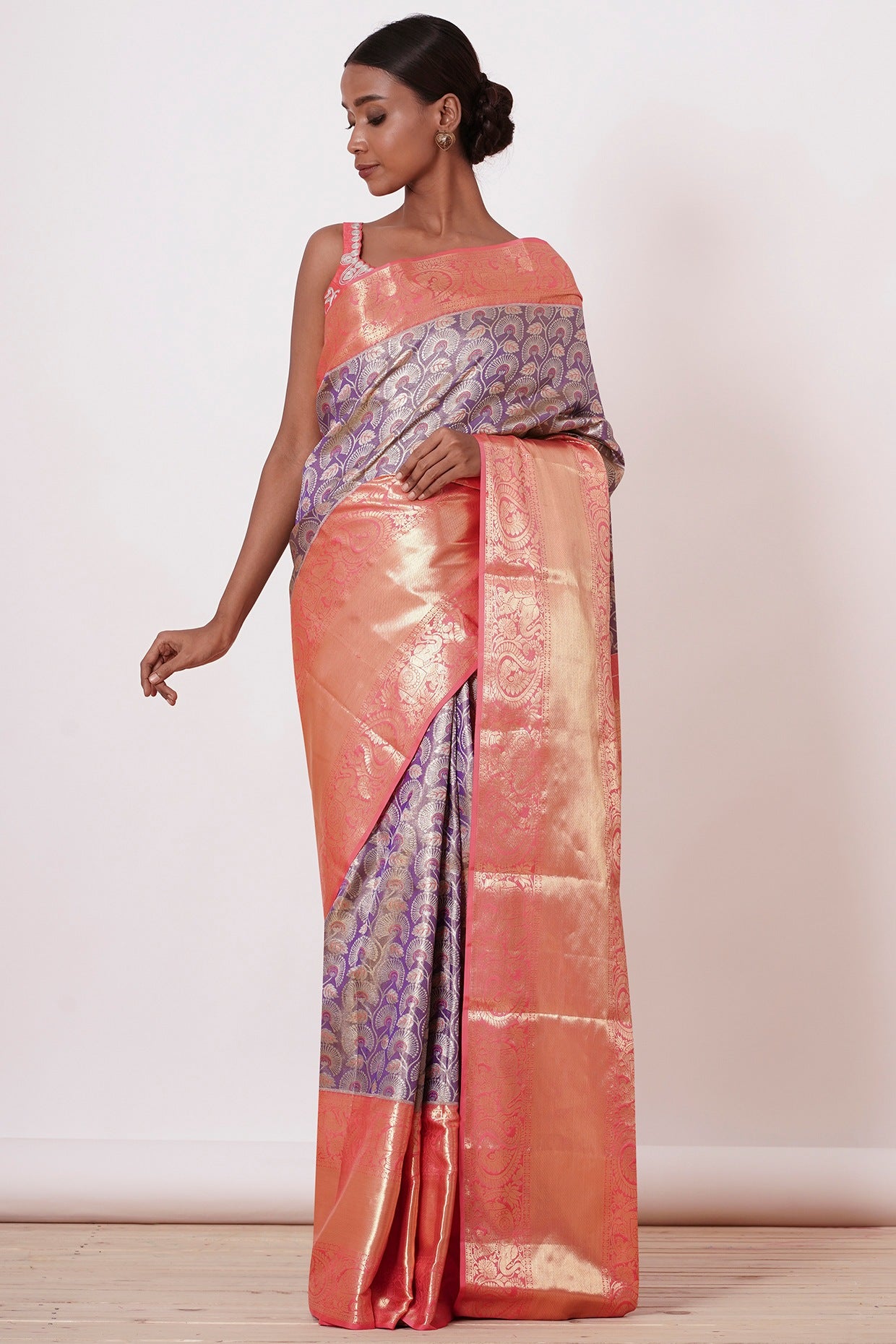 Violet Dharamavaram Silk Saree with thick intricate Peach Border and a Peach Blouse with all over Silver Zari Embroider
