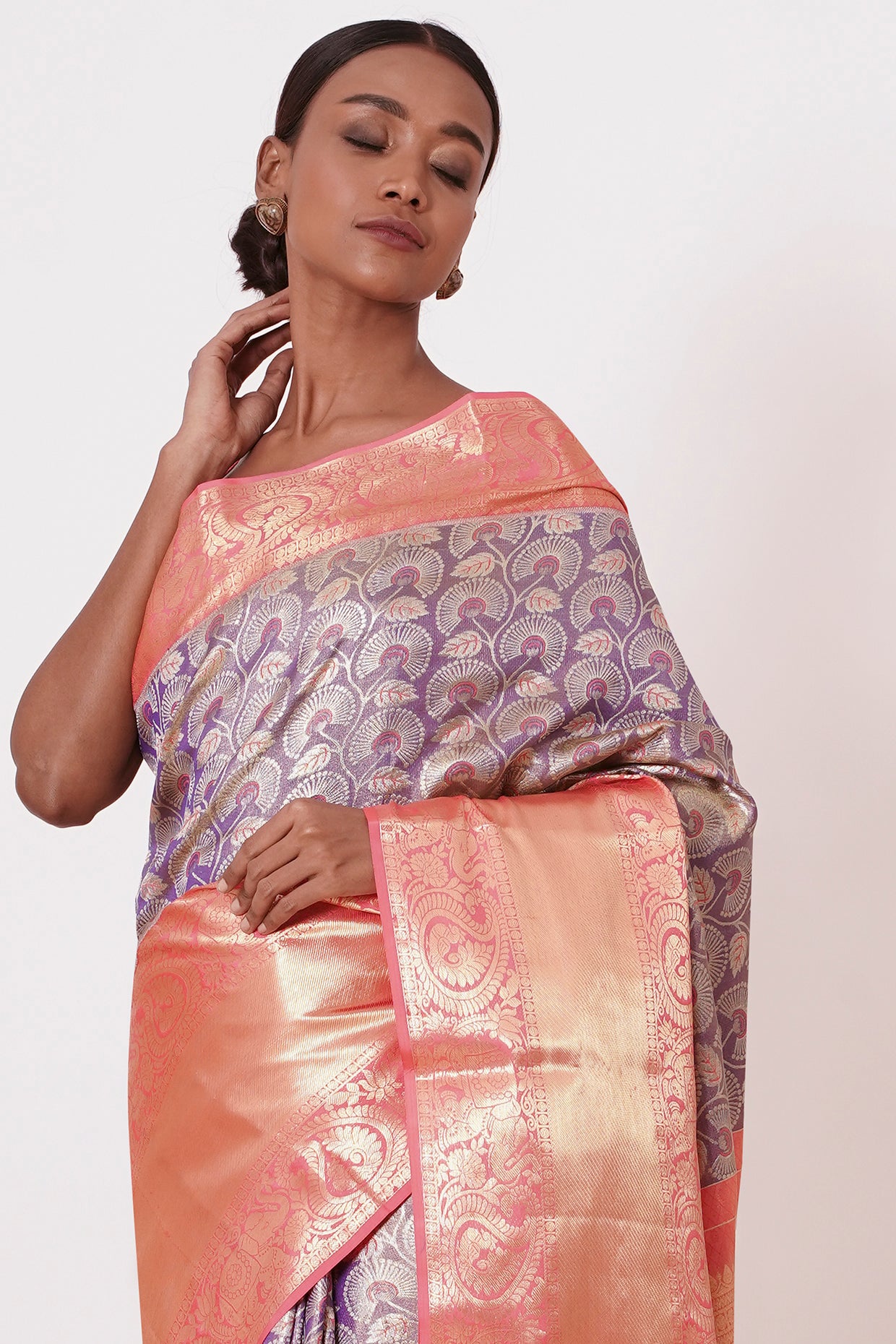 Violet Dharamavaram Silk Saree with thick intricate Peach Border and a Peach Blouse with all over Silver Zari Embroider