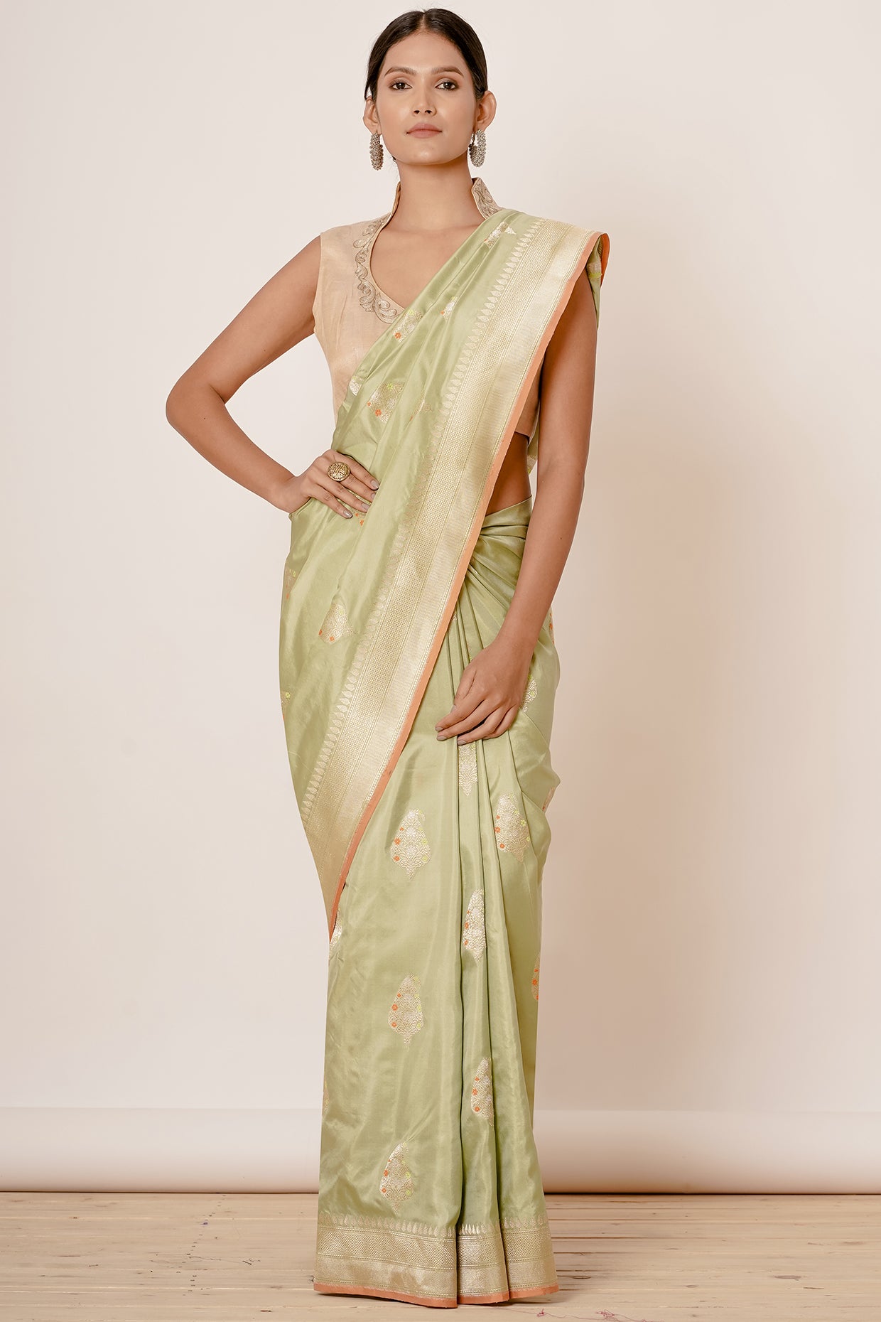 Dusty Pista Banarasi Silk Saree with Paisely Motifs and Gold Backless Blouse