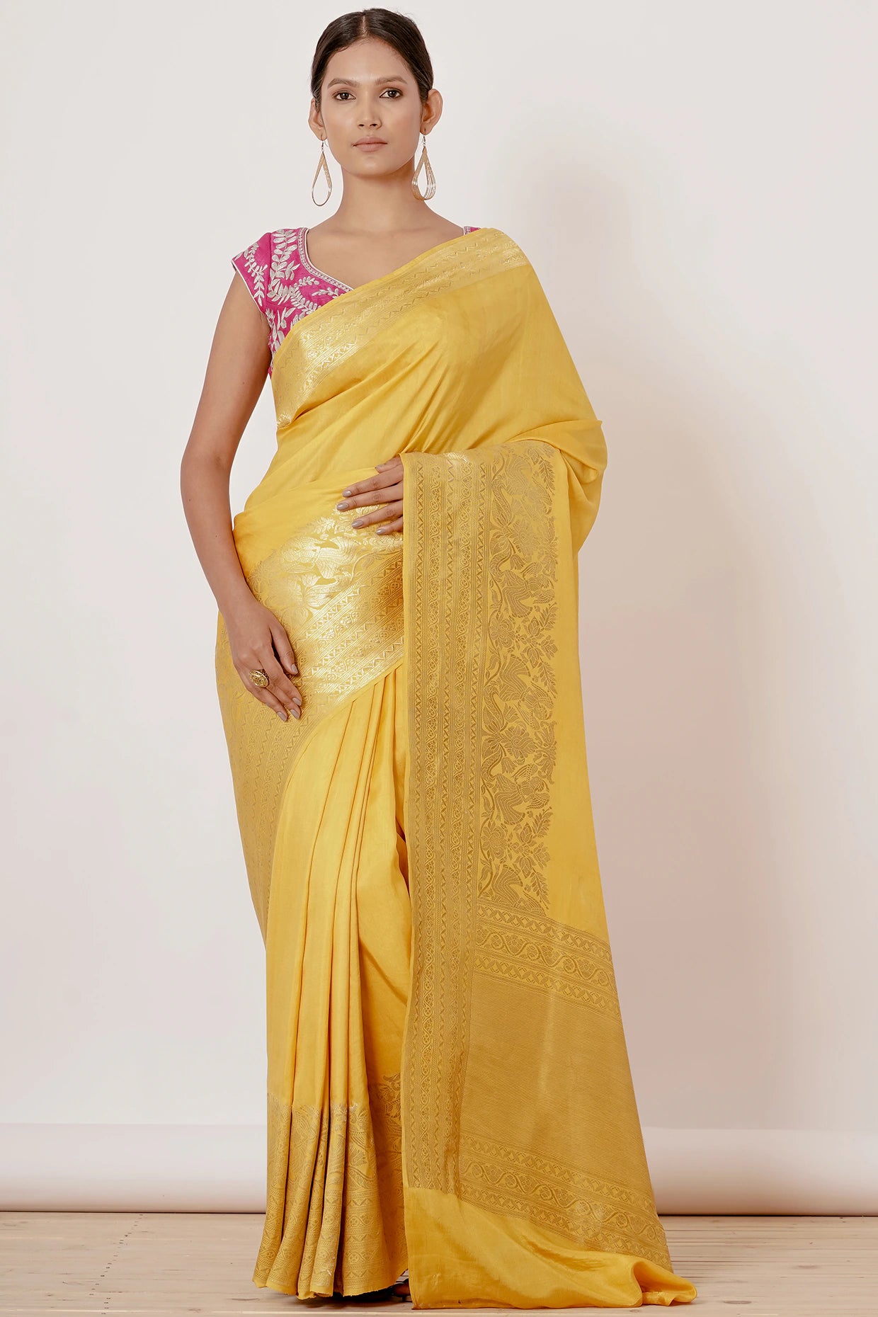 Bright yellow banrasi silk saree with pink blouse