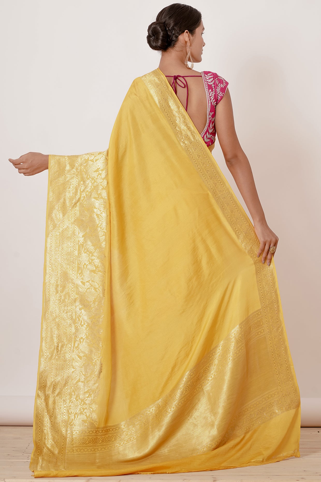 Bright yellow banrasi silk saree with pink blouse