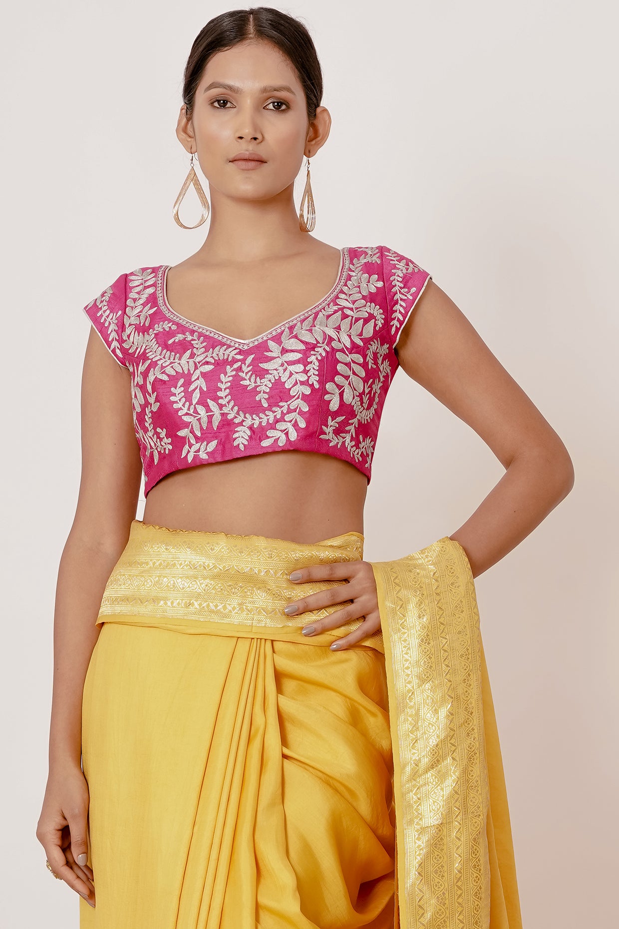 Bright yellow banrasi silk saree with pink blouse