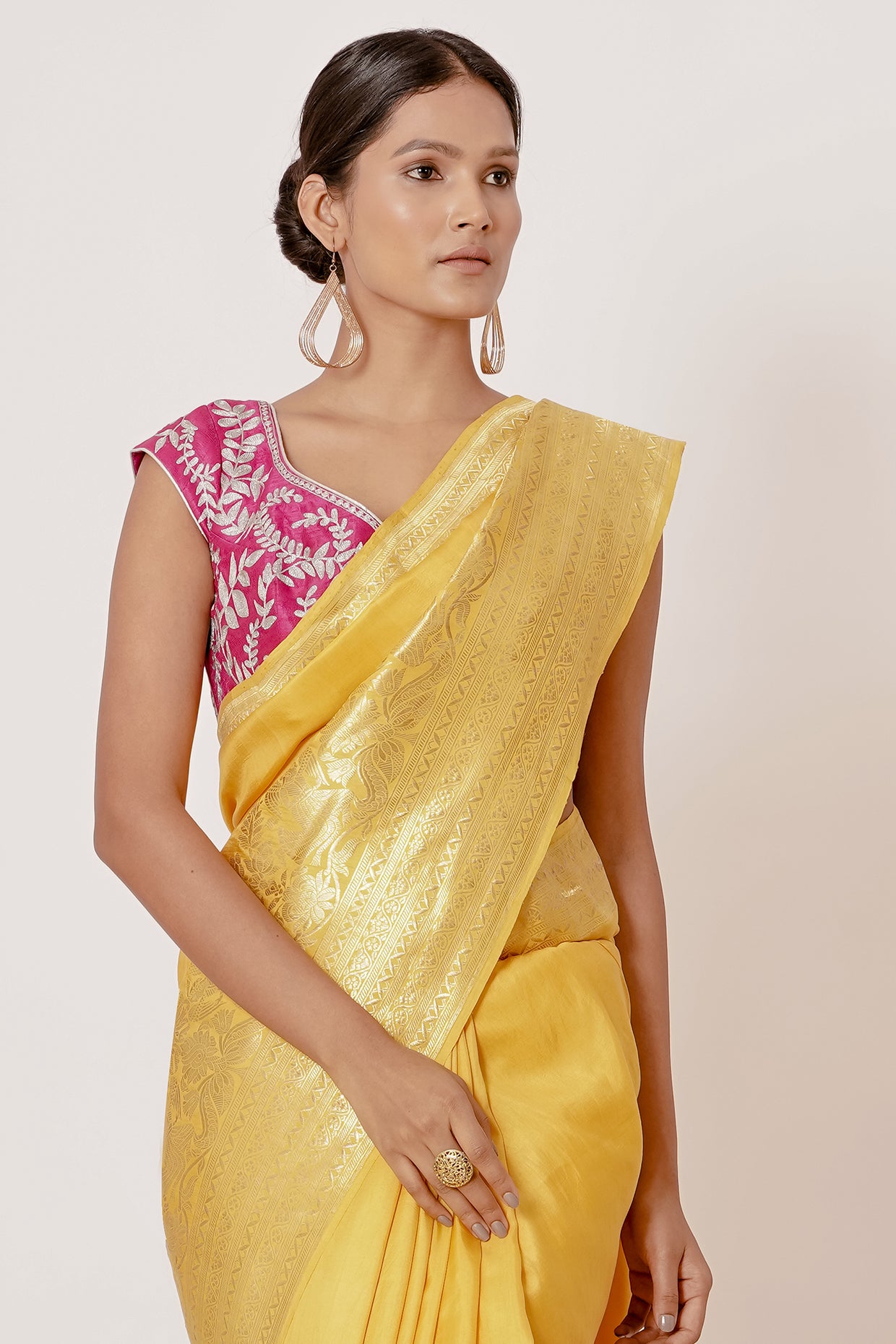 Bright yellow banrasi silk saree with pink blouse