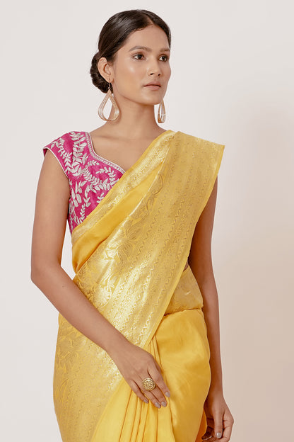 Bright yellow banrasi silk saree with pink blouse