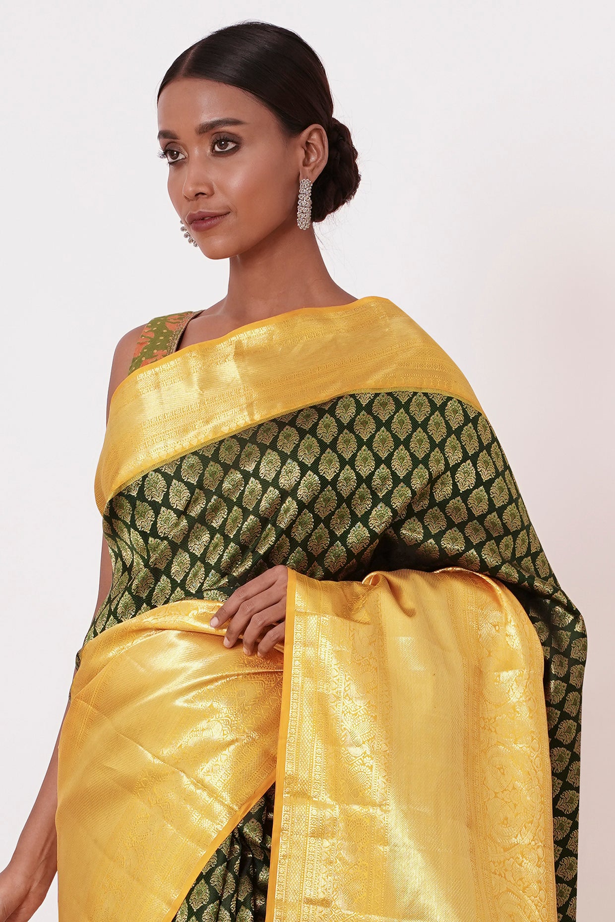 Dark Green Dharamavarm Silk Saree with Thick Yellow Intricate Border.