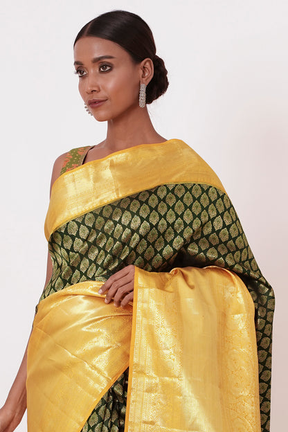 Dark Green Dharamavarm Silk Saree with Thick Yellow Intricate Border.