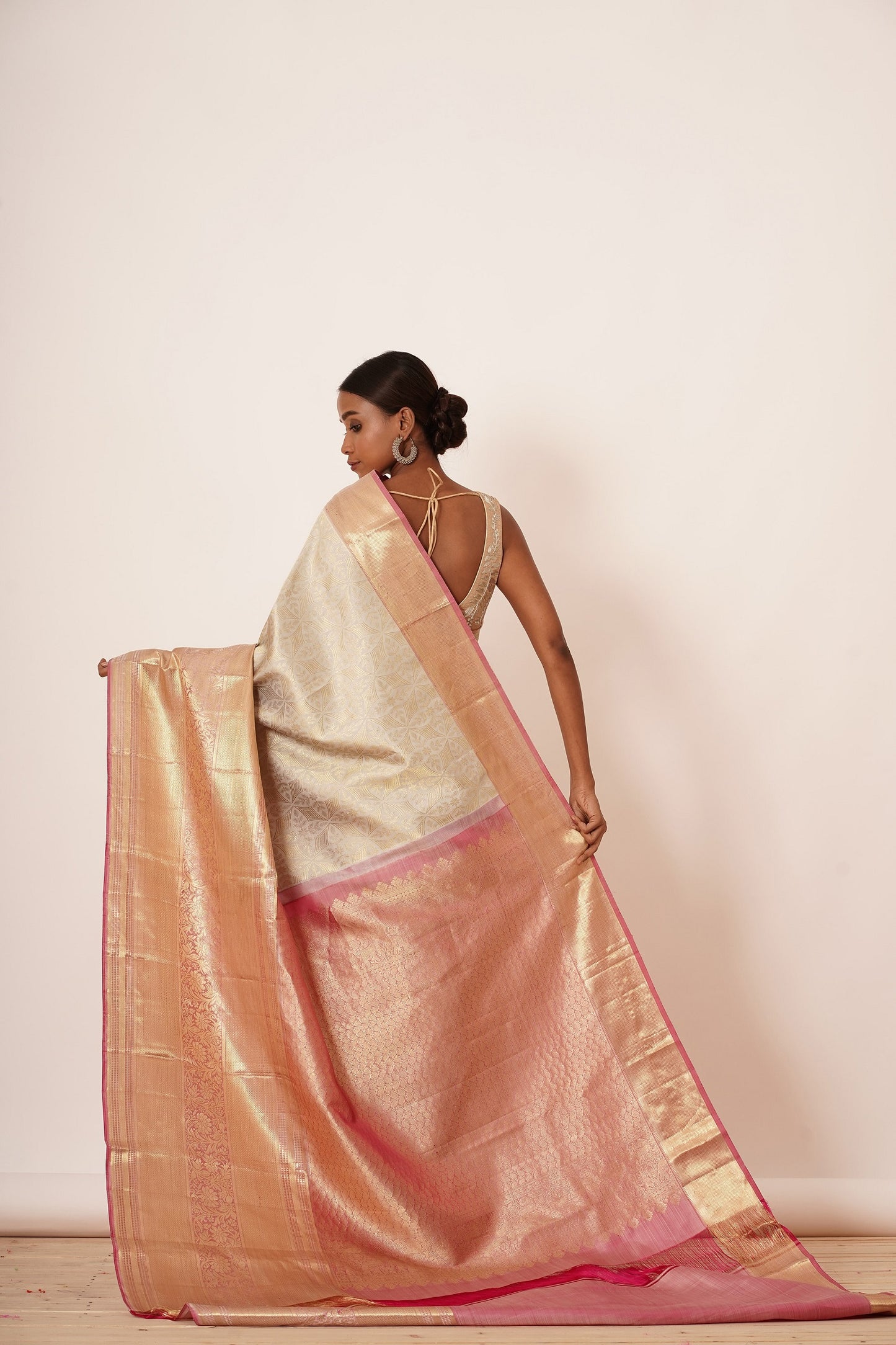 Ivory dharmavram Silk Saree with Thick intricate Gold Border. The Saree Comes with a Gold Blouse