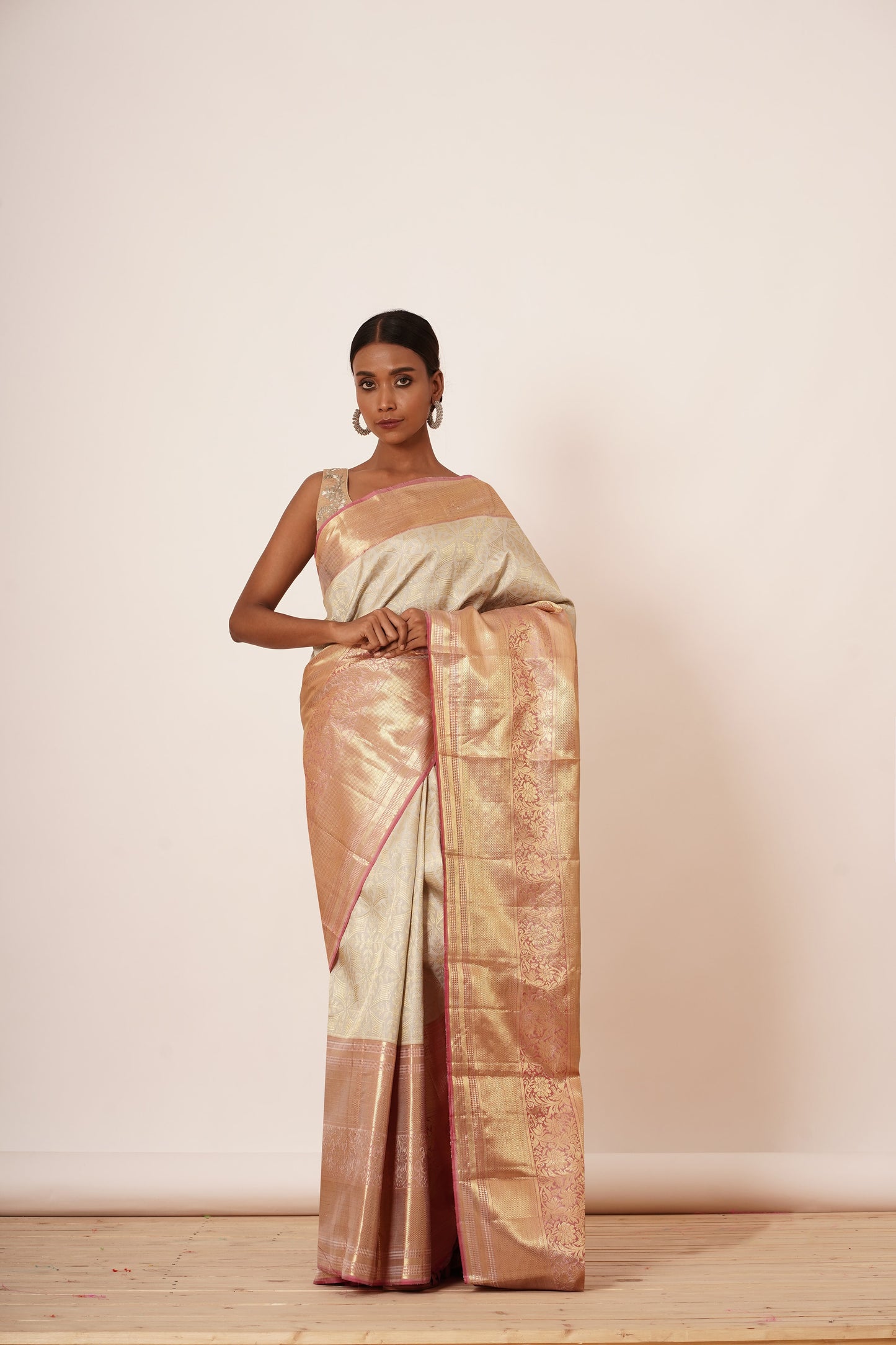 Ivory dharmavram Silk Saree with Thick intricate Gold Border. The Saree Comes with a Gold Blouse