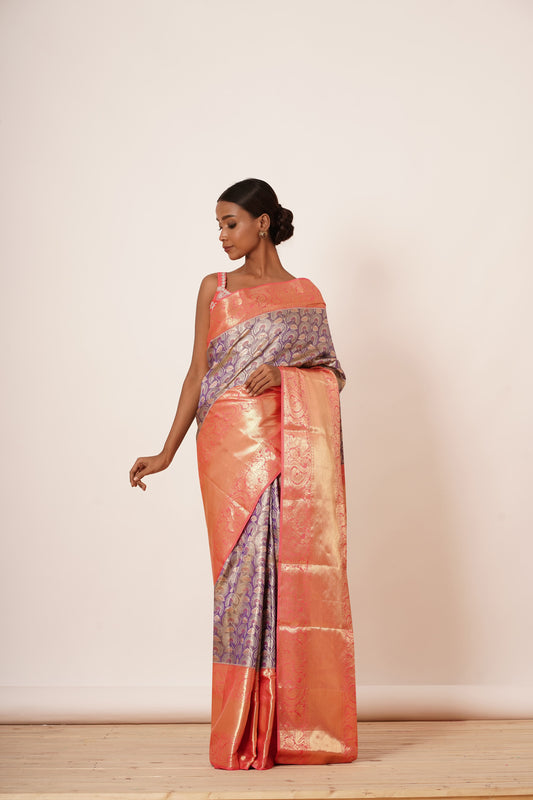 Violet Dharamavaram Silk Saree with thick intricate Peach Border and a Peach Blouse with all over Silver Zari Embroider