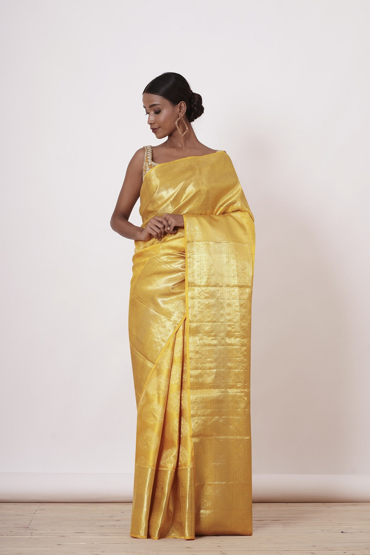 Royal Yellow Dharamavaram Silk Saree with a Gold Blouse .