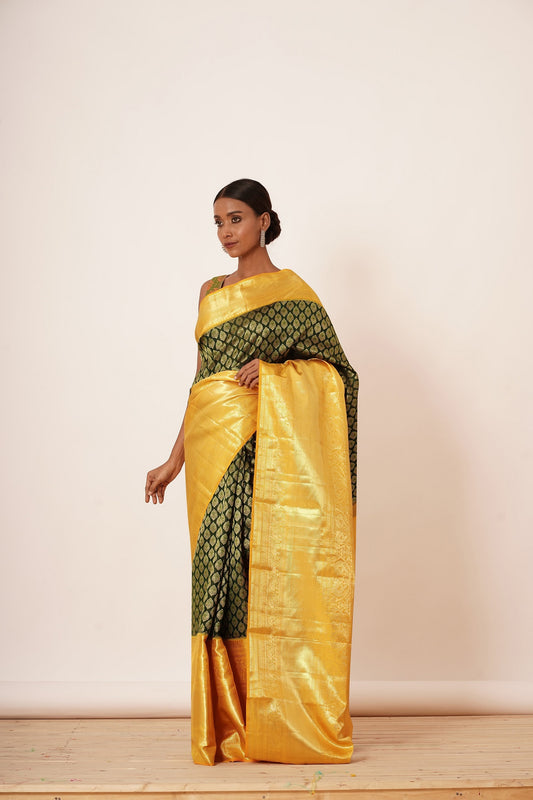 Dark Green Dharamavarm Silk Saree with Thick Yellow Intricate Border.