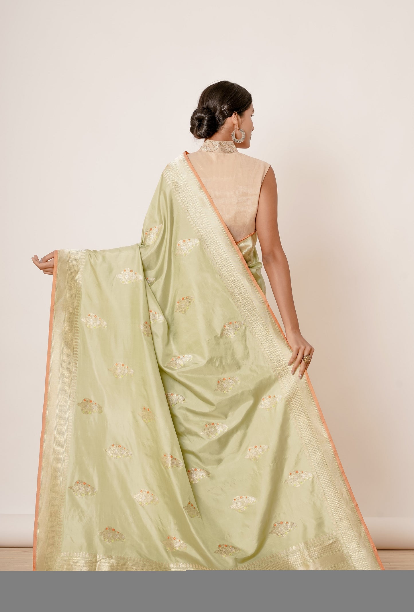 Dusty Pista Banarasi Silk Saree with Paisely Motifs and Gold Backless Blouse