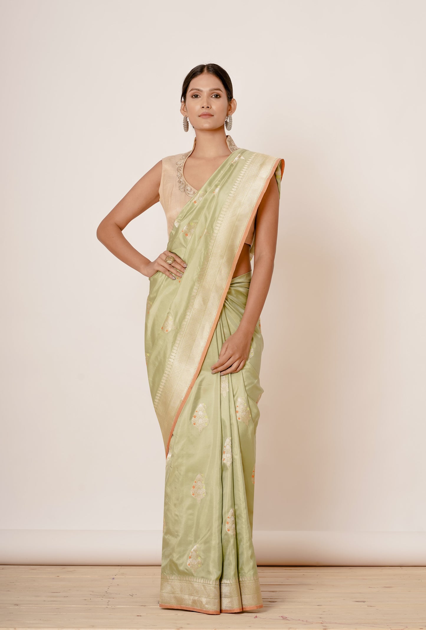 Dusty Pista Banarasi Silk Saree with Paisely Motifs and Gold Backless Blouse