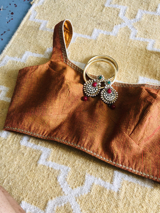 Brick red blouse with embroidery on neck and hem